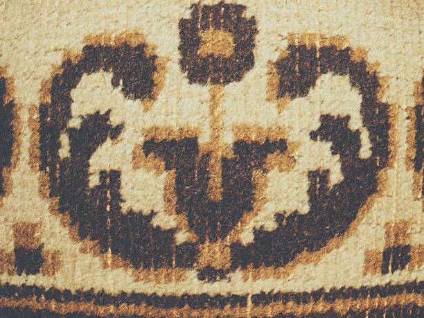 istock Carpet texture. Worn places with faded flowers 1128848093