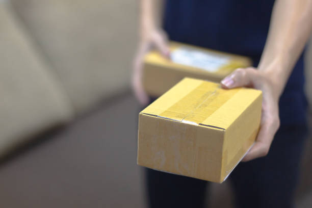 istock Man's hands holding the  carton box - courier and delivery service concept. 1128849275