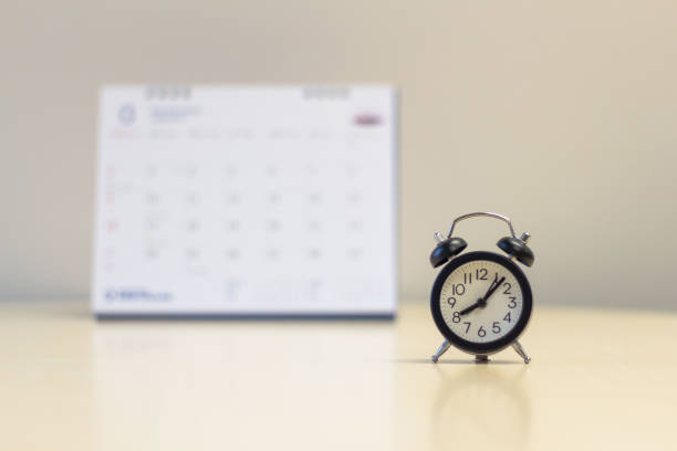 istock Alarm clock with calendar background - Time management concept. 1128849278