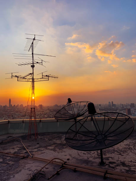 istock Televisions antennas with twilight sky in the city scape background. 1128849359