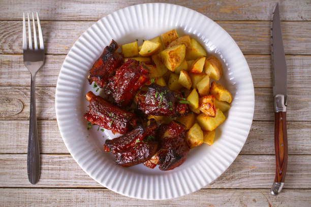 istock Grilled pork spare ribs with fries on white plate 1128850780