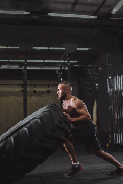 istock flipping a huge tire at the gym 1128851563