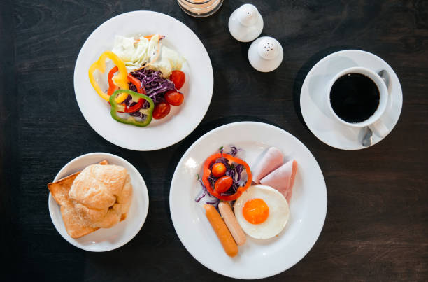 istock American breakfast sunny side up eggs, sausage, ham, fresh salad 1128851961