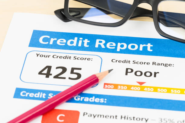 istock Poor credit score report with pen and calculator 1128852507