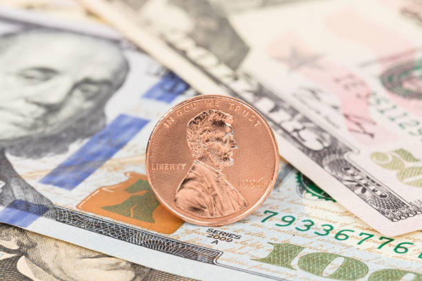 istock One cent coin stand on us dollar banknote money 1128852533