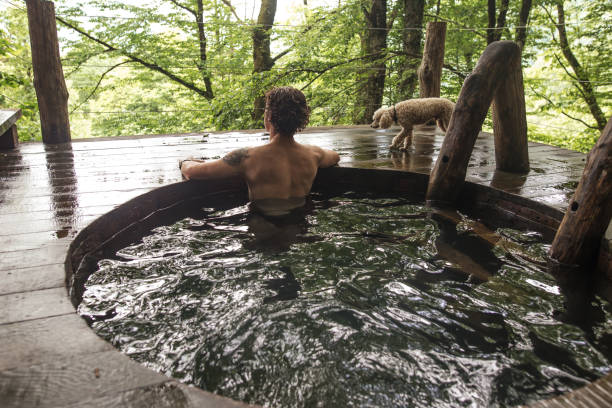 istock pensive naked guy is watching the birds in the forest 1128853356