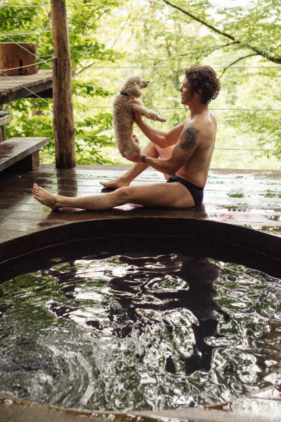 istock young man is going to have a bath with pediggree dog 1128853374