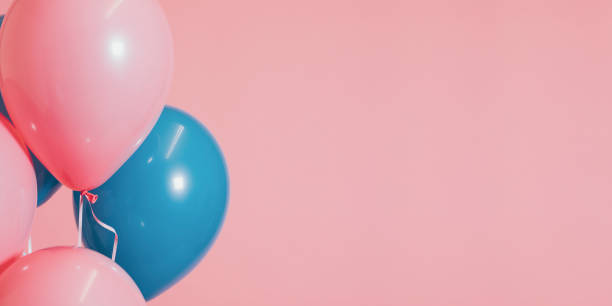 istock Pink and blue helium balloons 1128853471