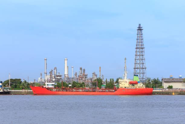 Oil refinery on water front and oil tanker