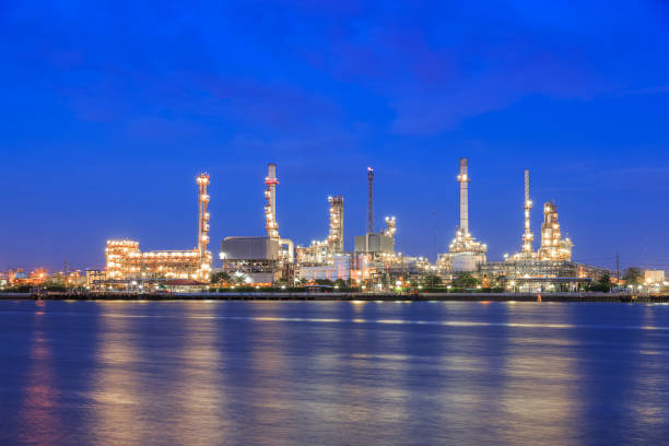istock Oil refinery on water front at twilight 1128853817