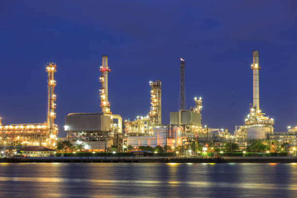 istock Oil refinery on water front at twilight 1128853827