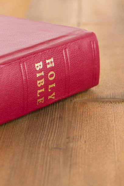 istock Red bible book on wooden table 1128856948