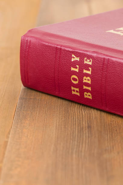 istock Red bible book on wooden table 1128856951