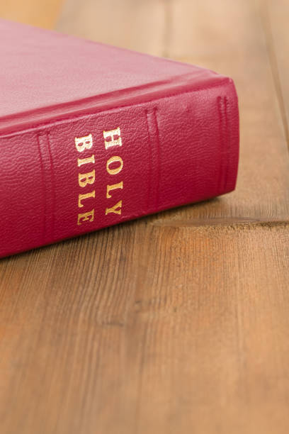 istock Red bible book on wooden table 1128856953