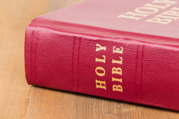 istock Red bible book on wooden table 1128856955