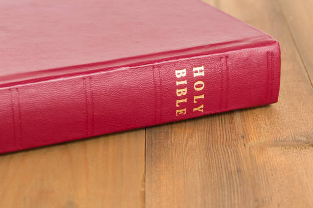 istock Red bible book on wooden table 1128856957