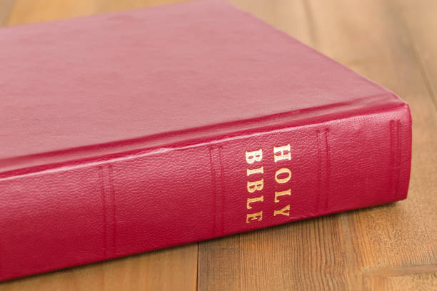 istock Red bible book on wooden table 1128856960