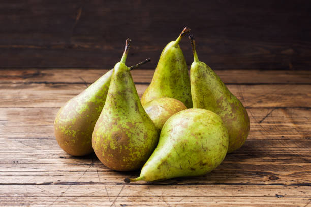 Fresh juicy Pears Conference on wooden rustic background. Fresh juicy Pears Conference on wooden rustic background conference pear stock pictures, royalty-free photos & images