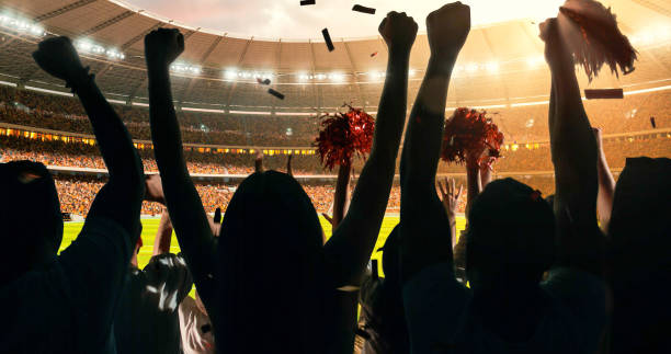 Fans cheering for sports team Group of cheering fans watch a sport championship on stadium. Their team wins and everybody are celebrating this event. People are dressed in casual cloth. sports event stock pictures, royalty-free photos & images