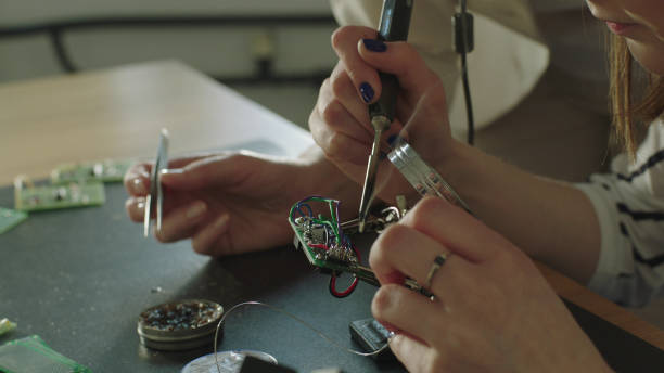 istock Female engeneers soldering and working on a project 1128858984
