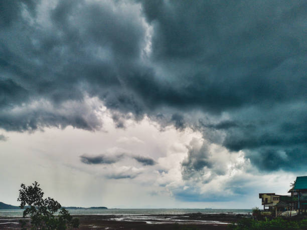The view from Old Town, Ko Lanta, Krabi province, Thailand, as a monsoon storm approaches.  Here the old way of life prevails with several over water stilt houses lining the bay to the Andaman sea.  Monsoon season is humid, wet and brings countless tropical storms.