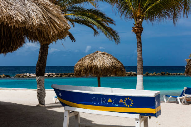 Small vintage Curacao boat on tropical Carribean beach
