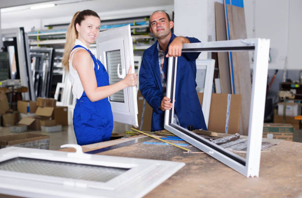 istock Portrait of smiling two workers  assembling pvc windows 1128864302