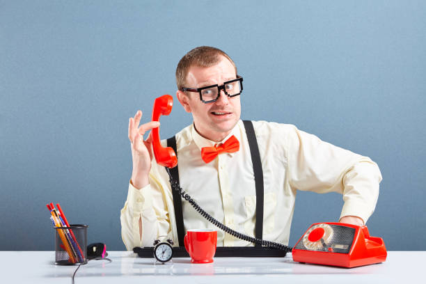 istock Unhappy nerd guy talking on phone 1128864408