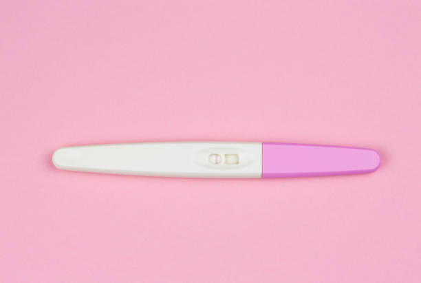 istock positive result on the pregnancy test over a pink background 1128864703