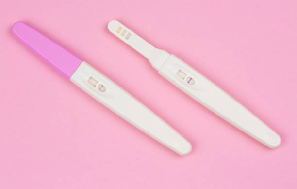 istock positive result on the pregnancy test over a pink background 1128864719