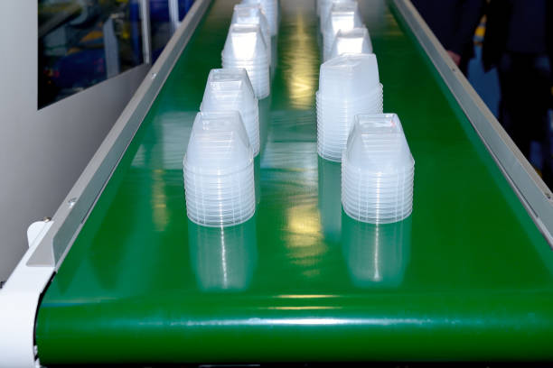 istock New plastic disposable containers on a conveyor belt. 1128864758