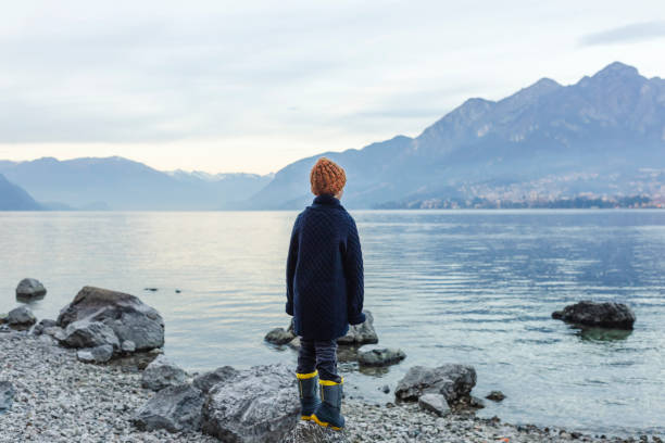 istock Hiker boy looking away over lake 1128865613
