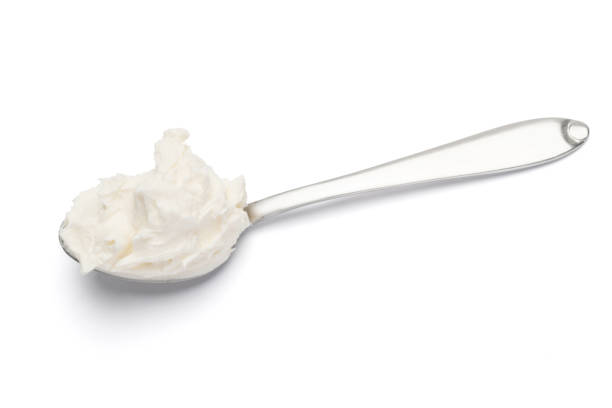 istock Traditional Mascarpone cheese in spoon isolated on white with clipping path 1128865772