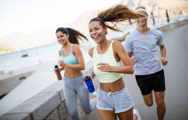 istock Group of young people jogging and running outdoors in nature 1128866233
