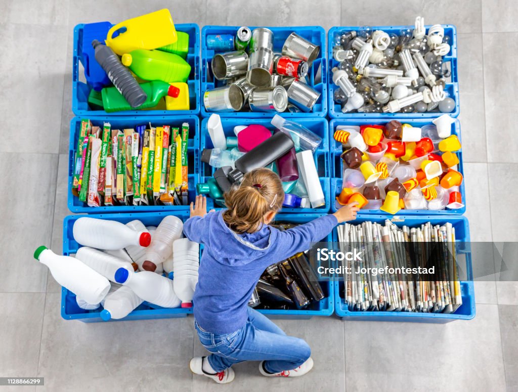 Garbage bins for recycling. Education. Garbage bins for recycling. A girl is using them. Recycling Stock Photo