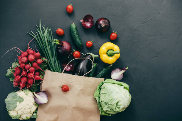 istock seasonal vegetables radish cabbage onions peppers cucumbers tomatoes dark background 1128867232