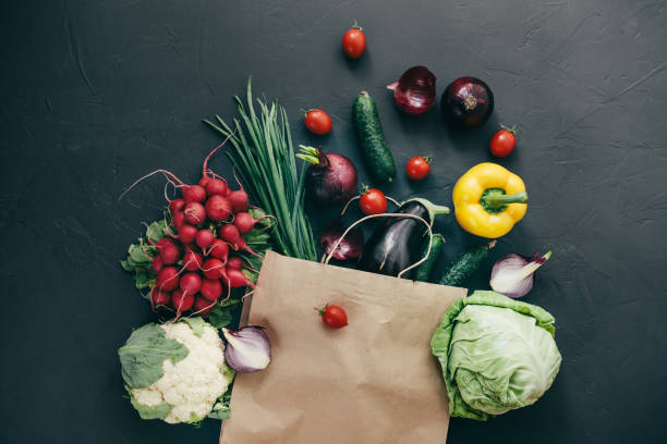 istock seasonal vegetables radish cabbage onions peppers cucumbers tomatoes dark background 1128867287