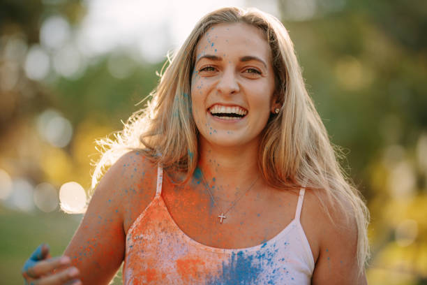 istock Woman playing holi with powder colours 1128868263