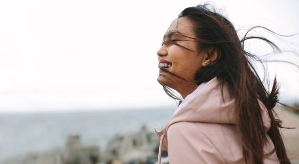 istock Smiling woman standing outdoors 1128869583