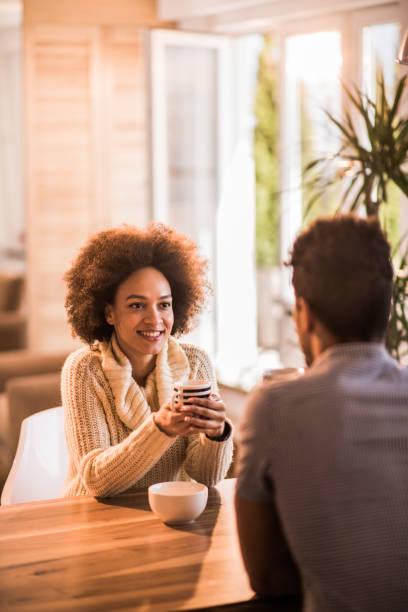 istock Happy African American couple talking while enjoying coffee time at home. 1128871100