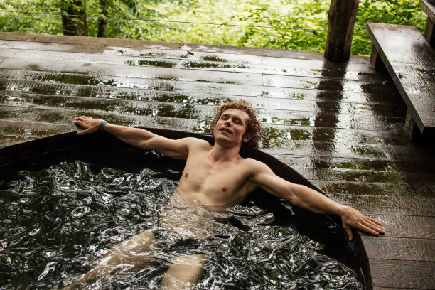 istock young handsome male taking enjoyment in bathing 1128871427