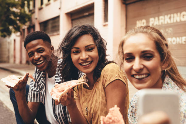 istock Friends taking selfie for social media 1128871515
