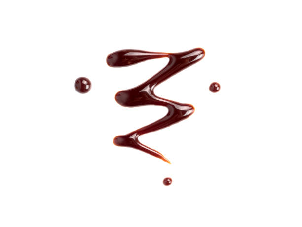 istock Chocolate sauce isolated on white background 1128872825