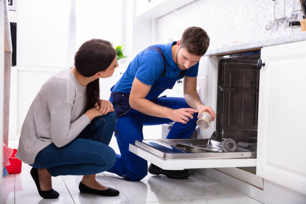 istock Repairman Fixing Dishwasher In Kitchen 1128872845