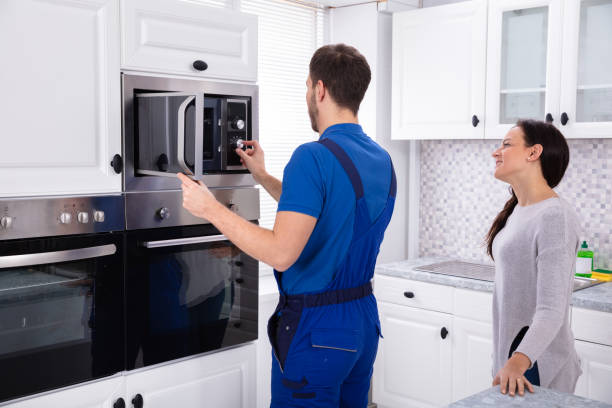 istock Young Technician Adjusting Temperature Of Oven 1128872877