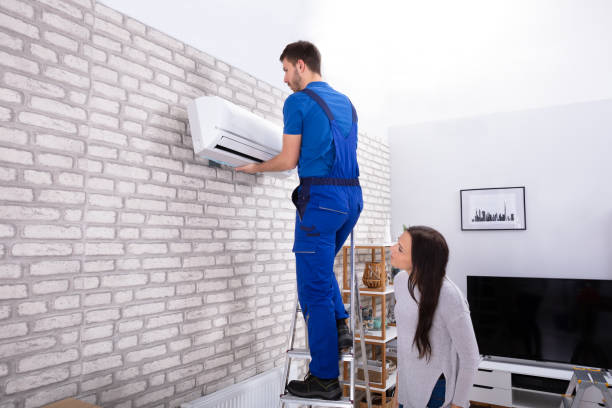 istock Male Technician Fixing Air Conditioner On Wall 1128872923