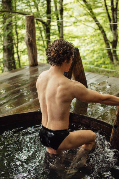 istock muscular sexy man is going up the staires after having bath 1128875232