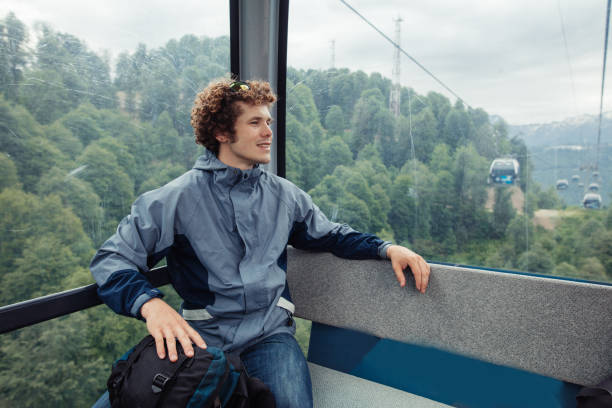 pleasant tourist is travelling in the funicular. cableway, tourism, travel, relaxation concept. close up photo.wonderful scenery on the background of the photo