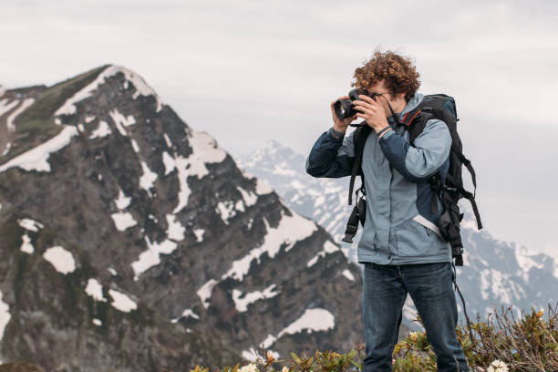 istock young photographer is working outdoors 1128875403