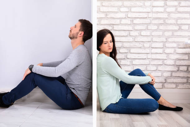 istock Sad Couple Sitting On Floor 1128875528